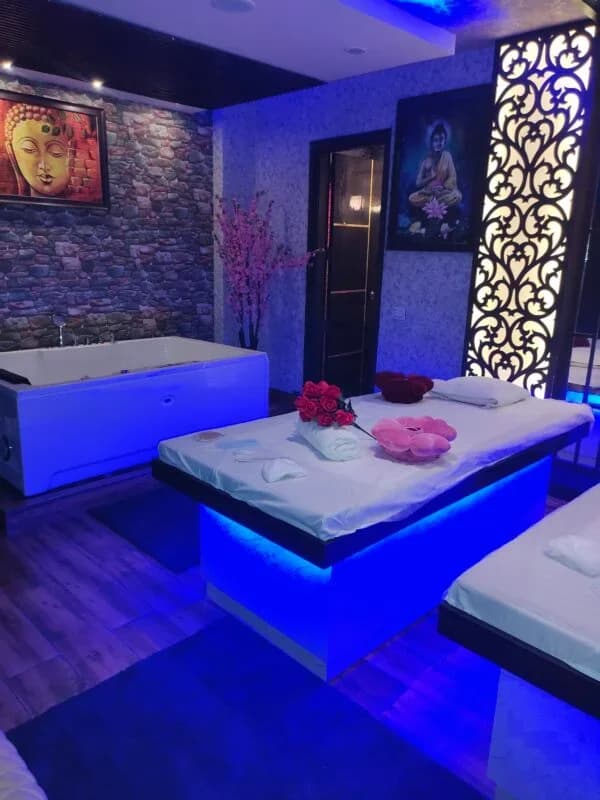 Exclusive Couple Massage Chamber with Hydrotherapy Jacuzzi and Buddha Wall Art at Amazing Wellness Spa