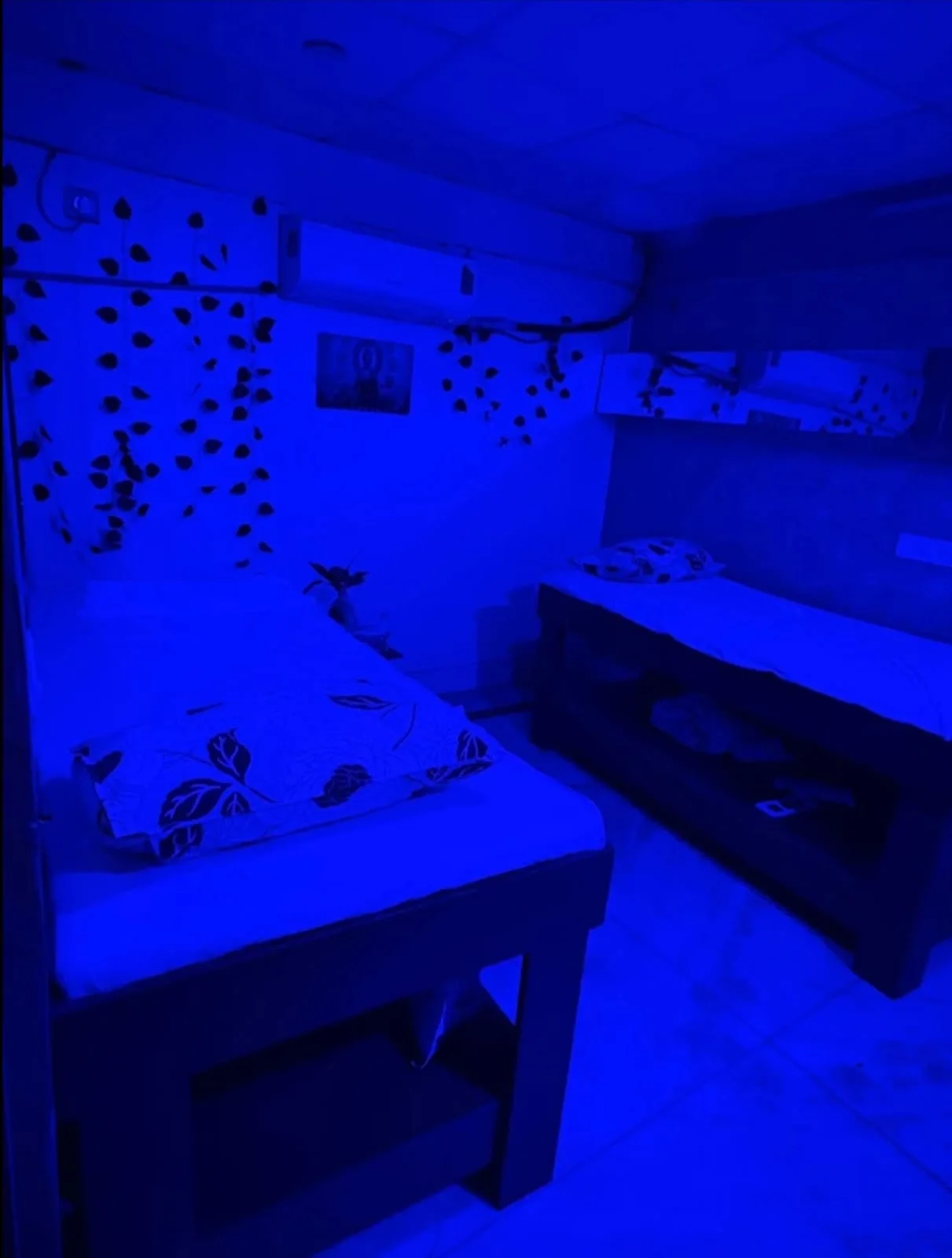 Atmospheric Double Massage Room with Twin Therapy Tables and Blue Relaxation Lighting