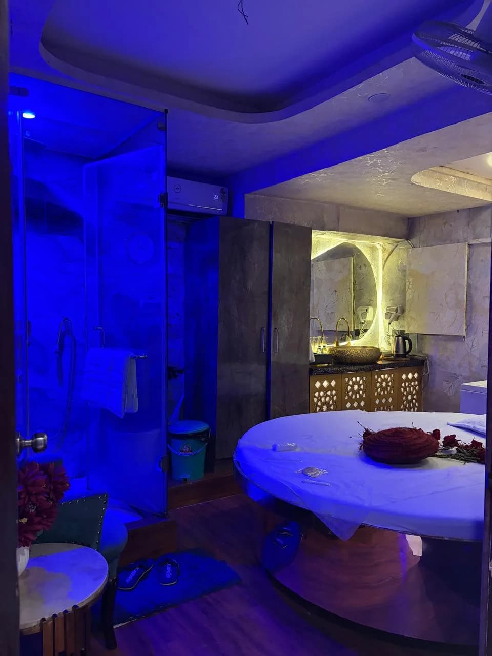 Round Bed Spa Suite with Rose Petal Decor and Glass Enclosed Rain Shower at Amazing Wellness Spa