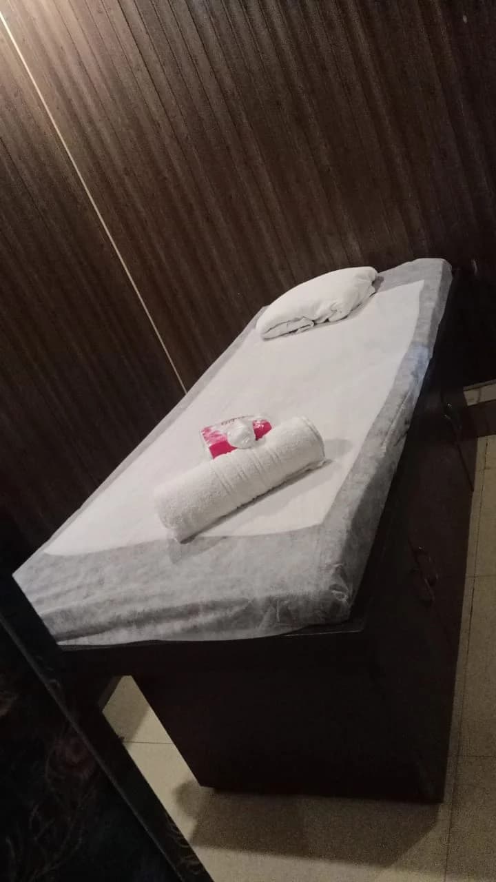 Single Massage Therapy Table with Clean Linens and Fresh Towels in Wood Paneled Room