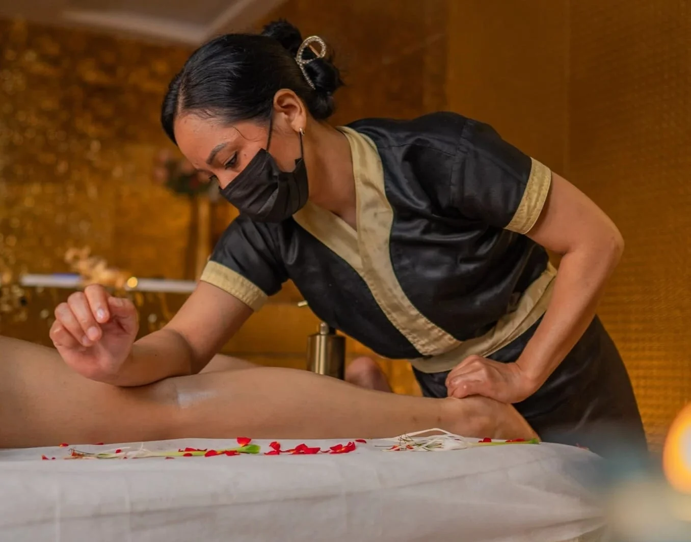 Certified Therapist Performing Soothing Leg Massage with Herbal Essential Oils at Amazing Wellness Spa