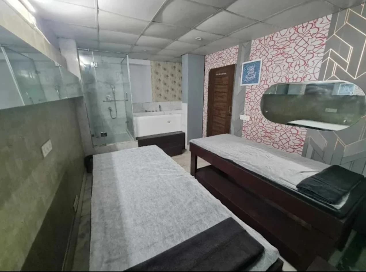 Couple Treatment Room with Twin Massage Beds, Glass Shower Enclosure and Private Bathtub