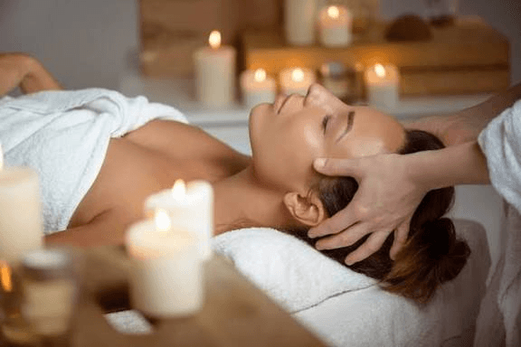 Professional spa therapist performing a soothing body treatment in a peaceful natural environment